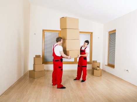 Professional movers handling furniture during a Kensalgreen relocation